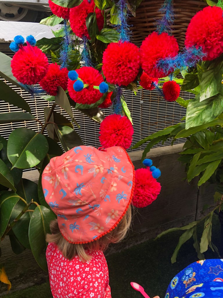 A young child approaches one of the fragrant flowers.