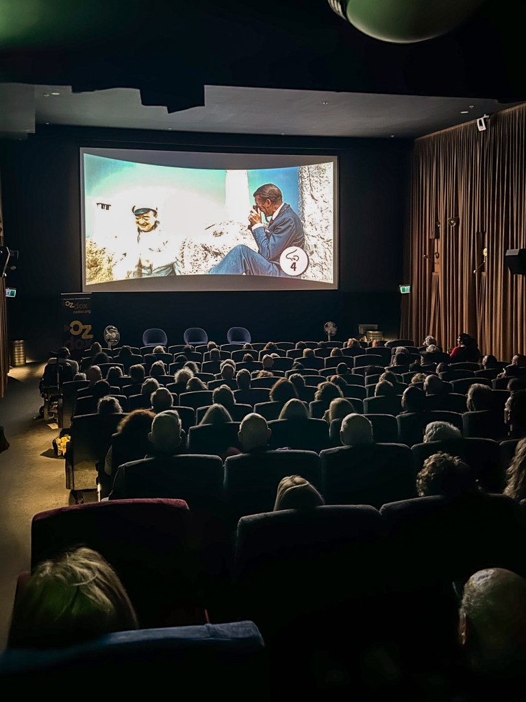 In a movie theater, the audience is cued to smell fragrance number four in their documentary goodie bags.