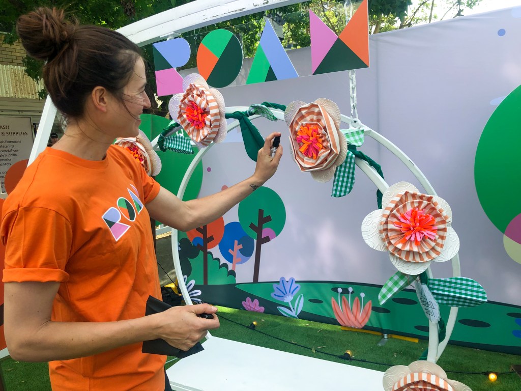 The floral vines, twisted around an Instagram frame, are sprayed with fragrances.